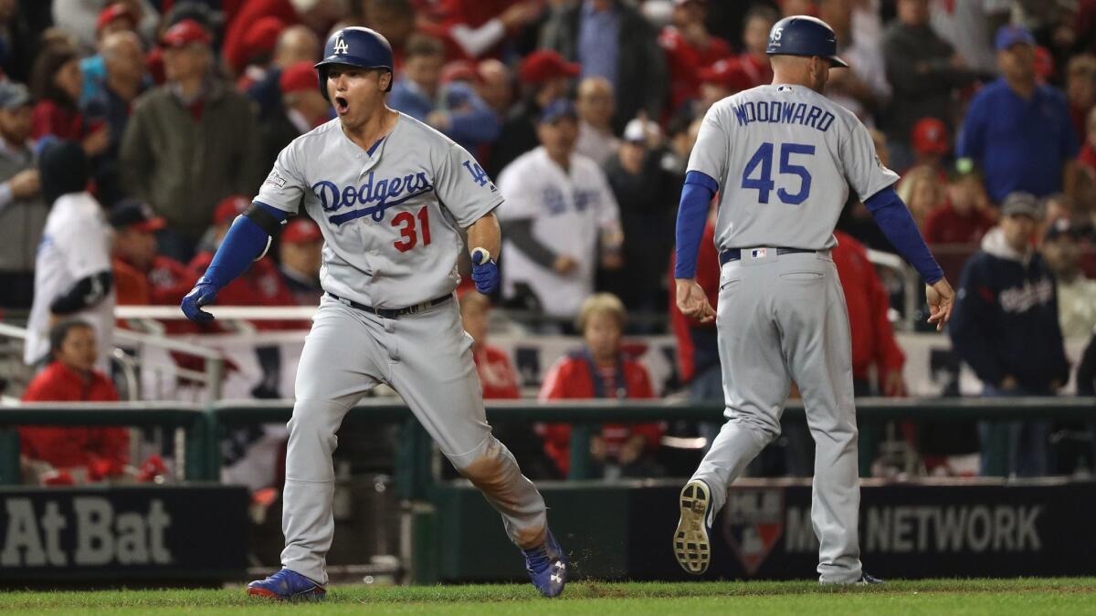 Dodgers outfielder Joc Pederson celebrates with third base coach Chris Woodward after hitting a home run against Washington on Oct. 13, 2016.