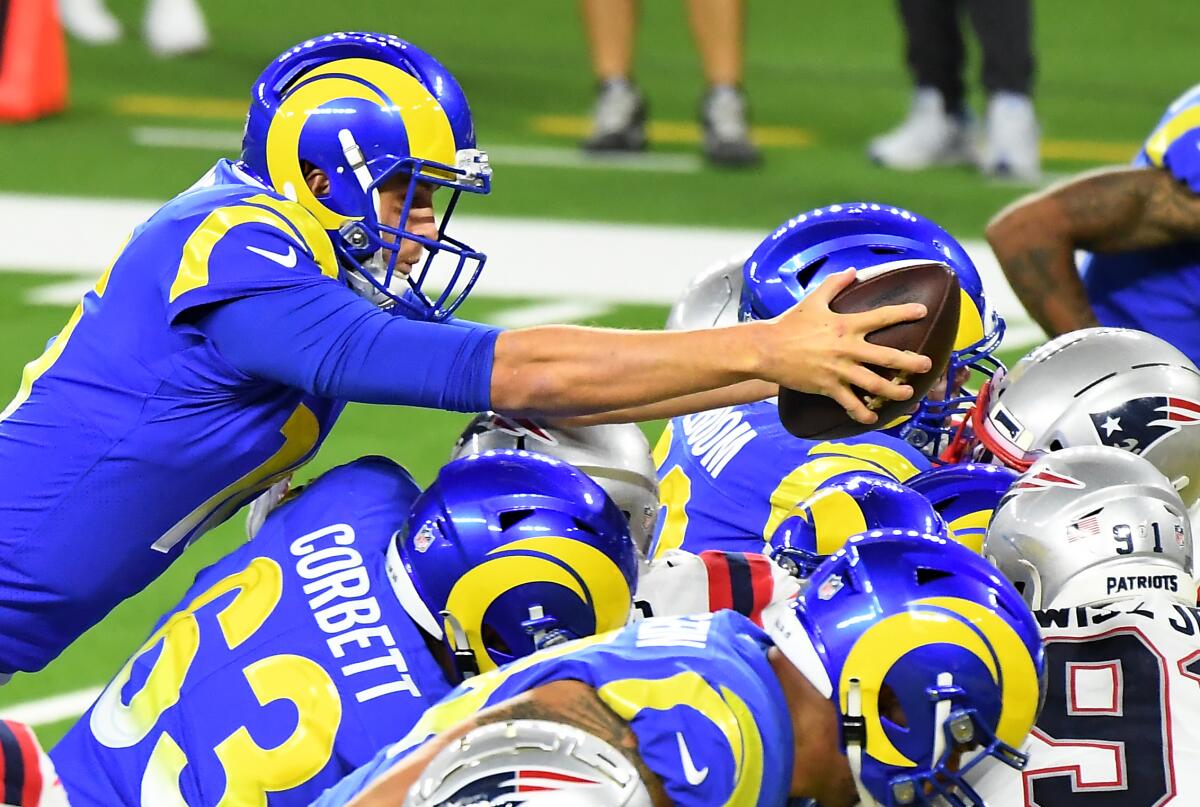 Rams quarterback Jared Goff leaps over the New England Patriots defense to score a touchdown.