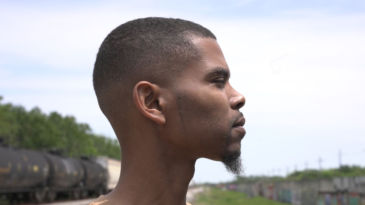 Side profile of a Black man with a goatee