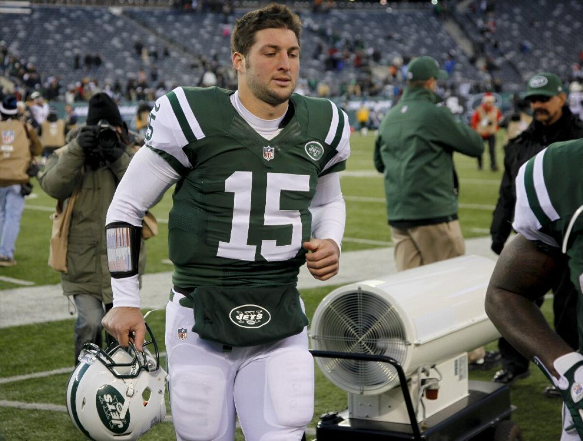 Tim Tebow walks off the field after the Jets' loss to the San Diego Chargers on Sunday.