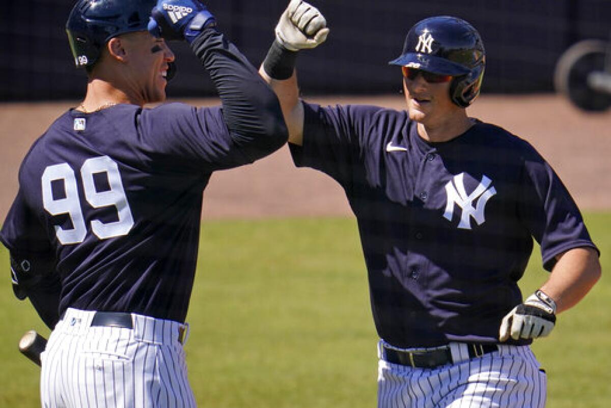 New York Yankees' DJ LeMahieu, right, celebrates with Aaron Judge after hitting a three-run home run off Pittsburgh Pirates pitcher JT Brubaker during the second inning of a spring training exhibition baseball game in Tampa, Fla., Saturday, March 13, 2021. (AP Photo/Gene J. Puskar