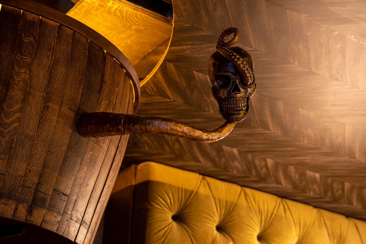 Decorations at Captain's Quarters include a Kraken tentacle around a skull.
