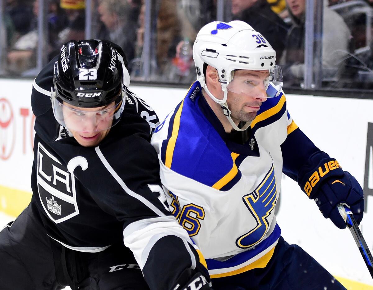 Kings forward Dustin Brown and St. Louis forward bump for position along the boards during the second period of a game at Staples Center on Jan. 9.