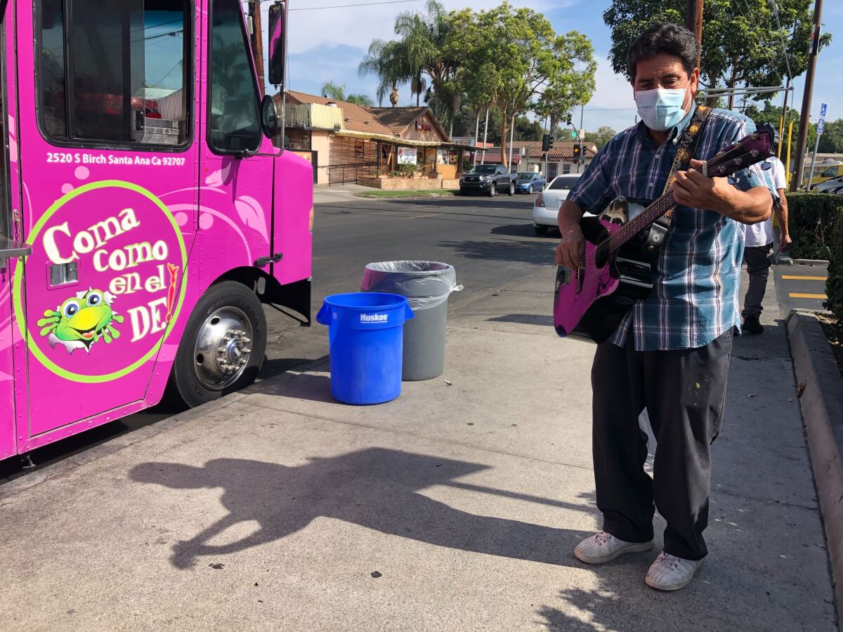  Jose Luis Acosta Escobedo performs for the lunchtime crowd at the Alebrije's food truck in Santa Ana. 