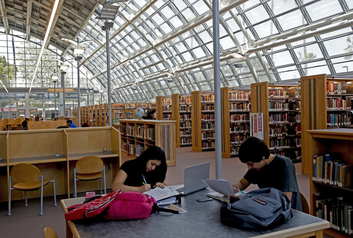 Nursing students Monica Lanco, 20, left, and Fernando Gomez, 22, study in the library before the ribbon-cutting ceremony Tuesday at El Camino College Compton Center. The state-of-the-art library opened last month after a seven-year delay.