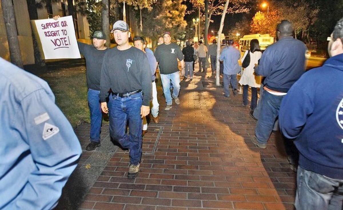 A couple hundred Glendale city workers of the GCA walk along Broadway in front of Glendale City Hall calling for their right to vote.