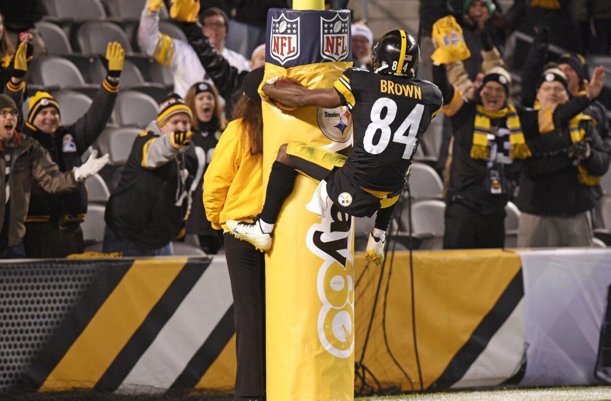 Pittsburgh receiver Antonio Brown leaps into the goal post after scoring a touchdown against Indianapolis on Sunday night.