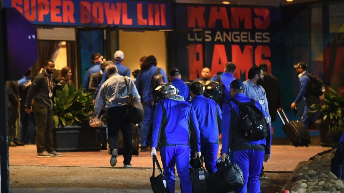 Rams players arrive at their hotel Sunday night in Atlanta.