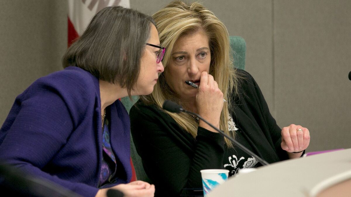 Assemblywoman Laura Friedman (D-Glendale), left, chairwoman of a subcommittee that will revise the Assembly's sexual harassment policies, confers with Assemblywoman Marie Waldron (R-Escondido), the committee co-chair, during a hearing in Sacramento.
