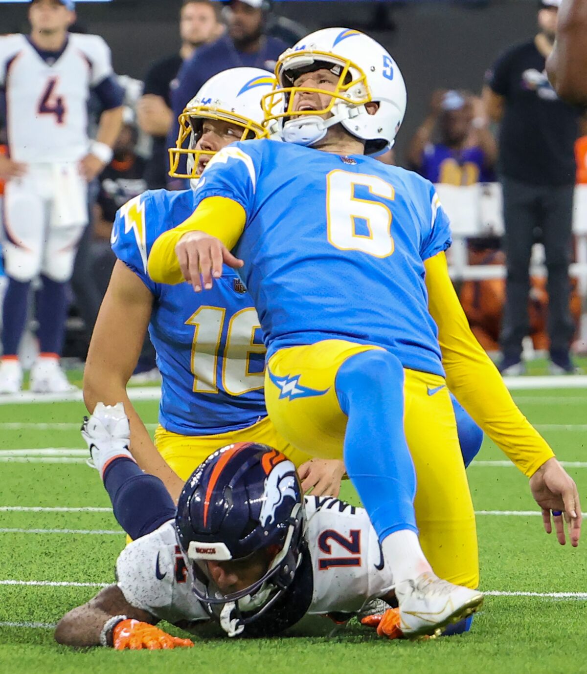 Injured Chargers kicker Dustin Hopkins (6) grimaces after making a game