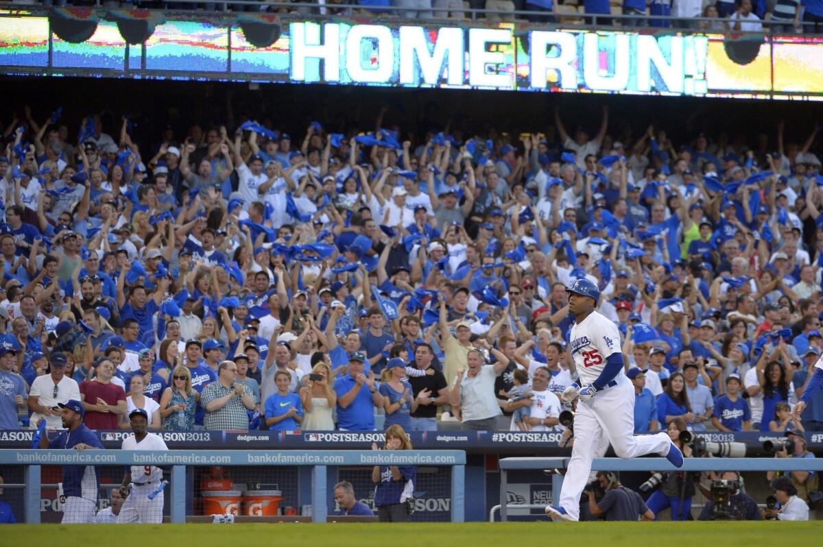 Dodgers fans celebrate a three-run home run by left fielder Carl Crawford during the Dodgers' win over the Atlanta Braves in Game 3 of the National League division series Sunday.