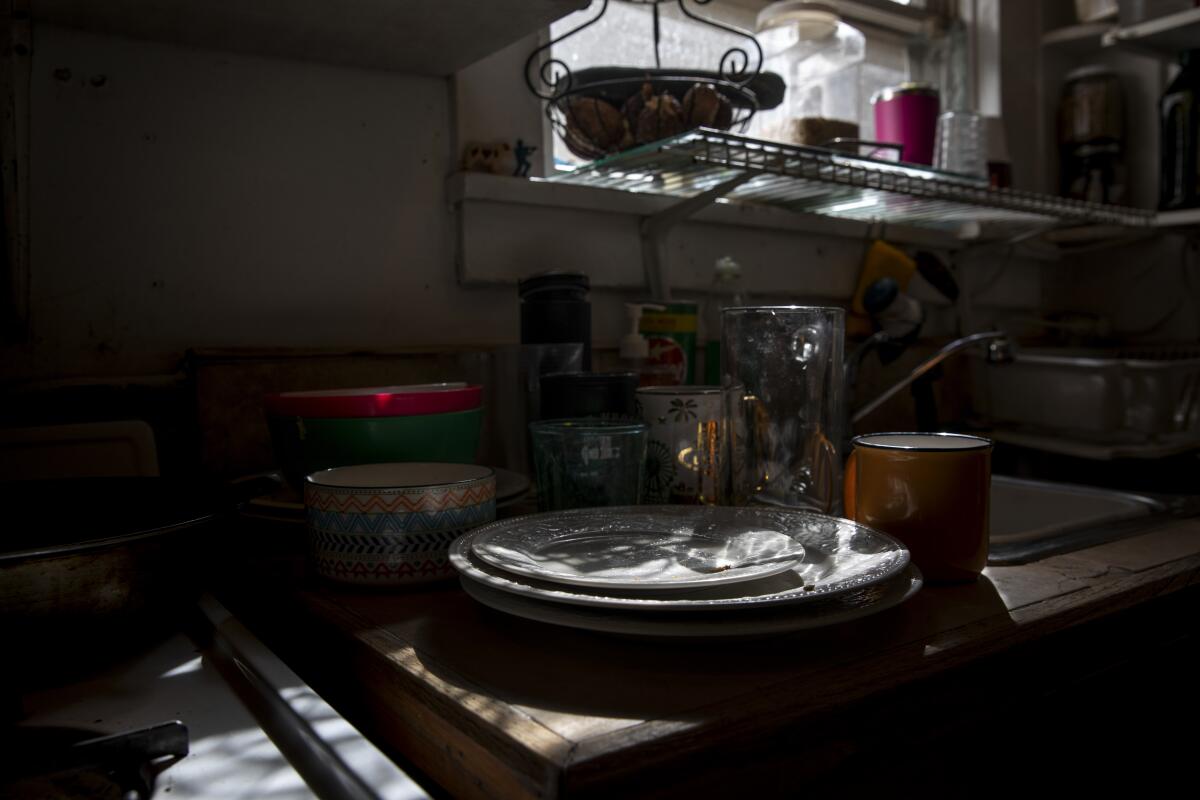 Dishes stack up in the kitchen of a San Diego family on Oct 5, 2021.