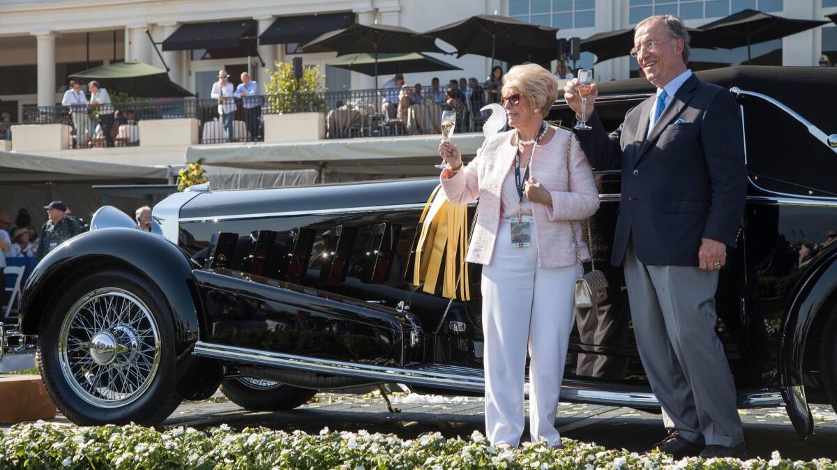 Jim and Dot Patterson lift a glass in celebration of their Best of Show win at the 65th Annual Pebble Beach Concours d'Elegance, awarded to them for their 1924 Isotta Fraschini Tipo 8A, in this Aug. 2015 file photo.