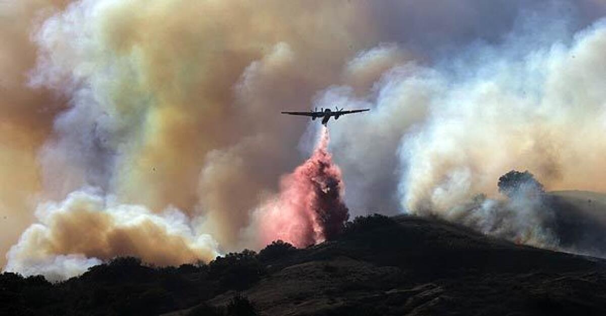 A plane drops fire retardant near the 91 Freeway in Anaheim Hills.