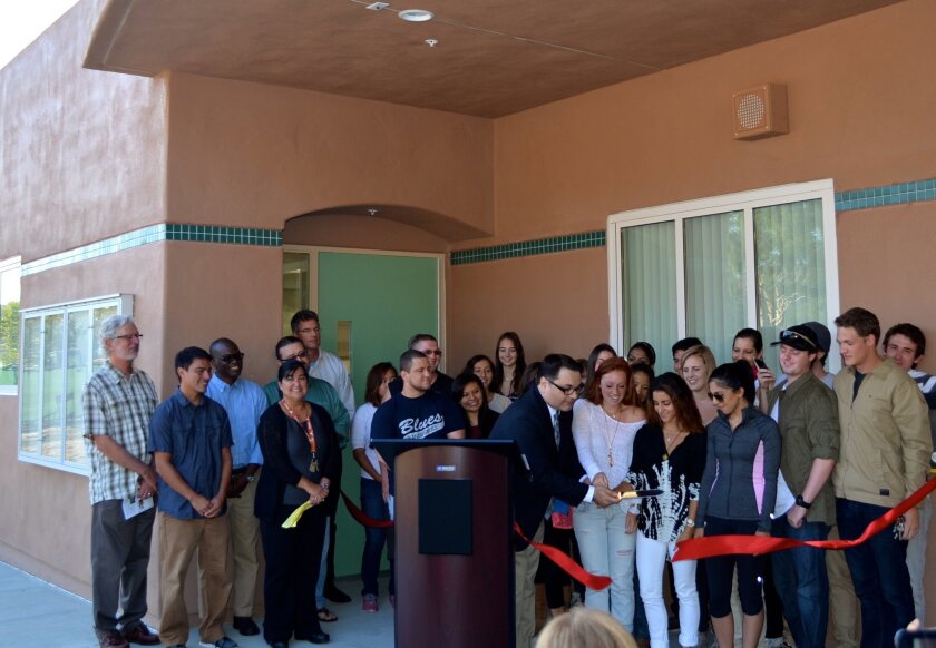 Students and MiraCosta College officials cut the ribbon for the new science building at the San Elijo campus. The building will help accommodate the growing demand for chemistry and biology classes.