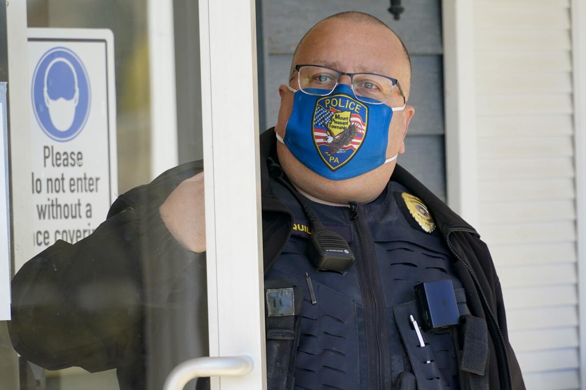 Police Chief Lou McQuillan answers the door at the municipal building.