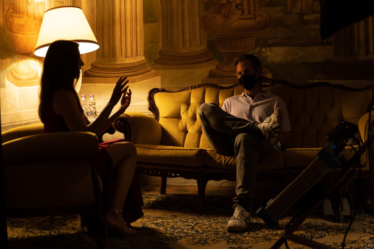 Alison Brie talks to Jeff Baena in a warmly lit room