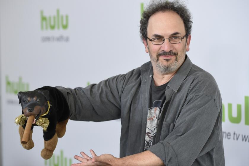 FILE - Robert Smigel, creator, executive producer and voice of "Triumph the Insult Comic Dog," poses with the puppet during the Television Critics Association 2016 Summer Press Tour at the Beverly Hilton on Aug. 5, 2016, in Beverly Hills, Calif. Federal prosecutors on Monday, July 18, 2022, declined to bring charges against Smigel and eight others associated with CBS’ “Late Show with Stephen Colbert” who were arrested in a building in the U.S. Capitol complex last month. (Photo by Chris Pizzello/Invision/AP, File)