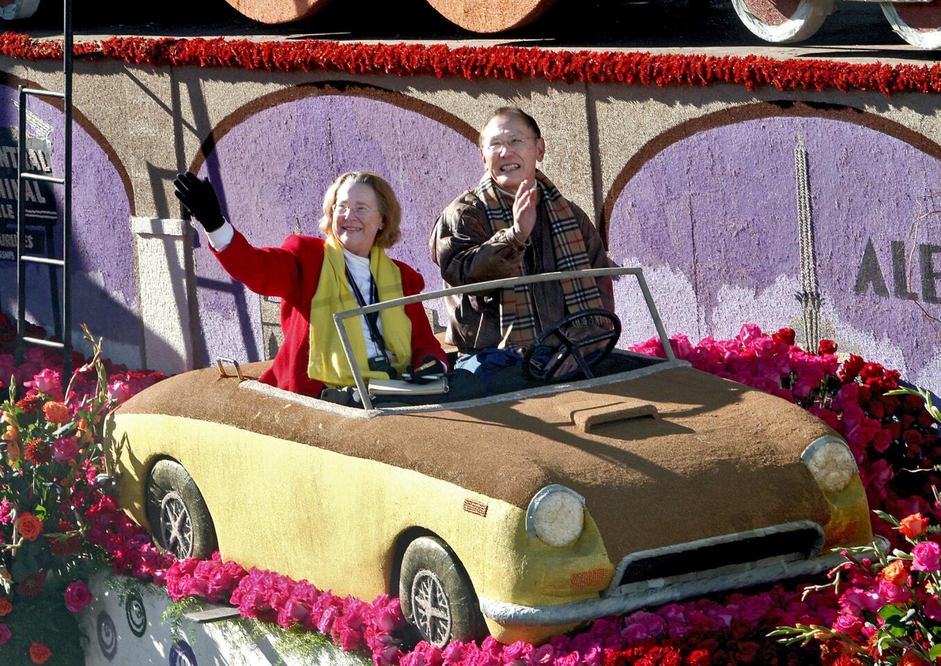 Katherine Yamada, left, and Glenn Yamada, right, ride on the city of Glendale float "Getting There is Half the Fun" as it rolls down Orange Grove Avenue for the the 2016 Rose Parade in Pasadena on Friday, Jan. 1, 2016.