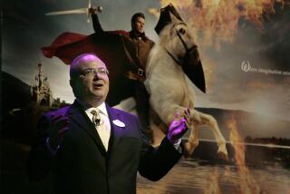 Disney Chairman of Parks Jay Rasulo introduces the photographic works of Annie Leibovitz that will be used in a Disney Parks advertizing campaign during a press conference at the Walt Disney World Contemporary resort hotel in Lake Buena Vista Fla. on Friday, Jan. 26,2006. Soccer king David Beckham, photo illustration background, plays a prince in the new Disney Parks' campaign --his first showpiece endorsement since announcing his move to Los Angeles. Beckham was one of the celebrities photographed last month in the roles of Disney movie characters for a "Year of a Million Dreams" promotion for Disney theme parks.(AP Photo/Reinhold Matay)