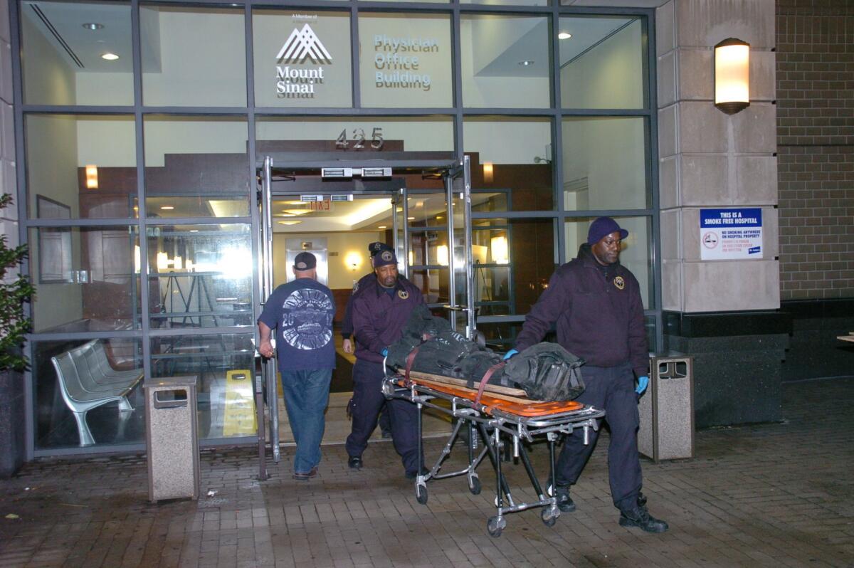 The body of Dmitriy Kanarikov, 35, is removed from a building in New York.