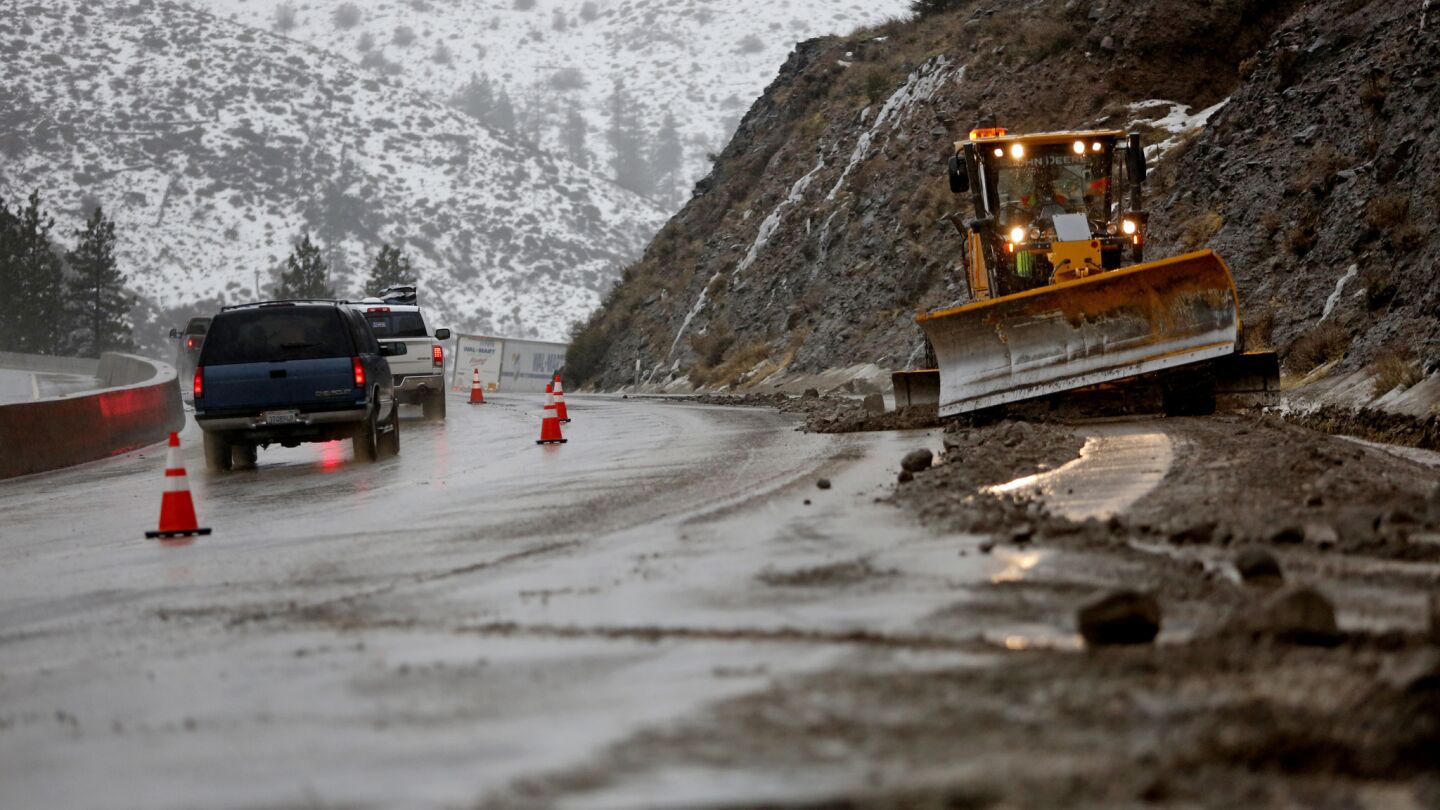 Traffic is backed up while CalTrans removes falling rocks and mud which closed one westbound lane along Interstate 80 east of Truckee, near Floriston, Calif.