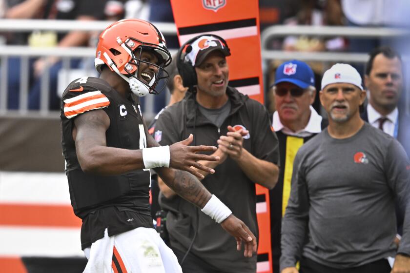 Cleveland Browns quarterback Deshaun Watson, left, celebrates a touchdown against the Tennessee Titans during the second half of an NFL football game Sunday, Sept. 24, 2023, in Cleveland. (AP Photo/David Richard)