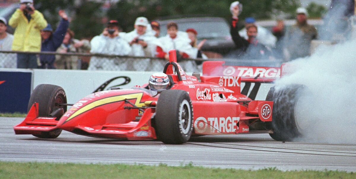 Alex Zanardi, of Italy, celebrates his victory by doing donuts during his cool down lap after winning the Texaco Havoline 200, Aug. 17, 1997, at Road America in Elkhart Lake, Wis. Zanardi has been inducted into the 16th class of the Walk of Fame in absentia on Thursday, April 7, 2022. (AP Photo/Timothy E. Black)