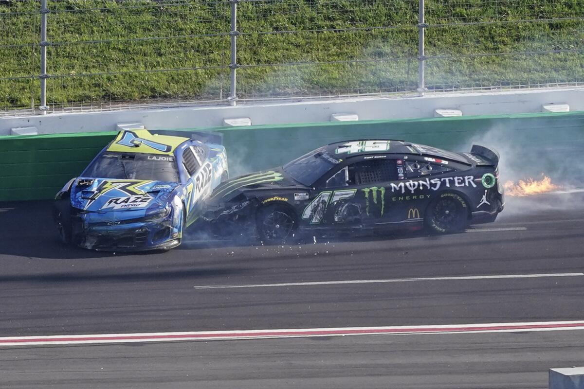 NASCAR Cup Series drivers Corey LaJoie (7) and Kurt Busch (45) crash on the last lap of the NASCAR Cup Series auto race at Atlanta Motor Speedway, Sunday, July 10, 2022, in Hampton, Ga. (AP Photo/Bob Andres)