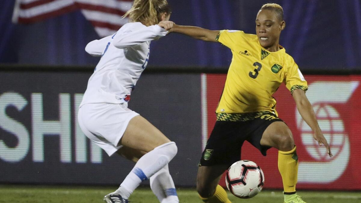 Emily Sonnett, left, of the United States defends against midfielder Shanise Foster of Jamaica during the second half of a CONCACAF Women's Championship semifinal game Sunday in Frisco, Texas. The U.S. won 6-0.