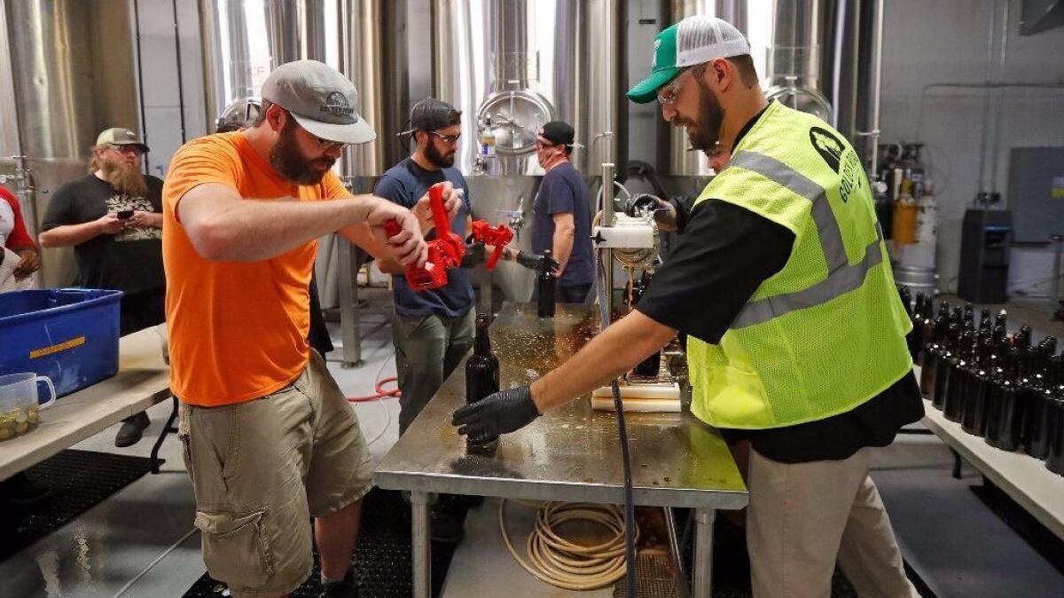 Brewers and packing technicians from Golden Road Brewing in Los Angeles bottle up special release beers at the new Golden Road Brewing in Anaheim in preparation for its soft opening on Nov. 18.