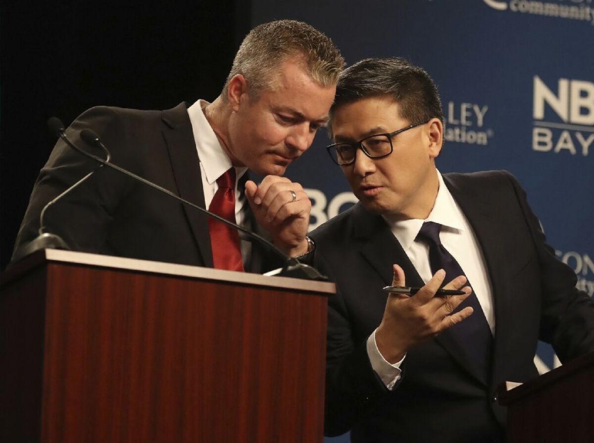 Republican gubernatorial candidate Travis Allen, left, talks with Democratic candidate John Chiang during a debate at the California Theatre, Tuesday, May 8, 2018, in San Jose, California.
