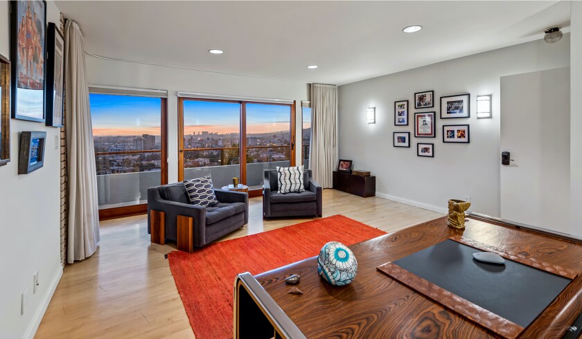 The hillside home includes three levels of decks, balconies and patios, as well as a swimming pool and spa.