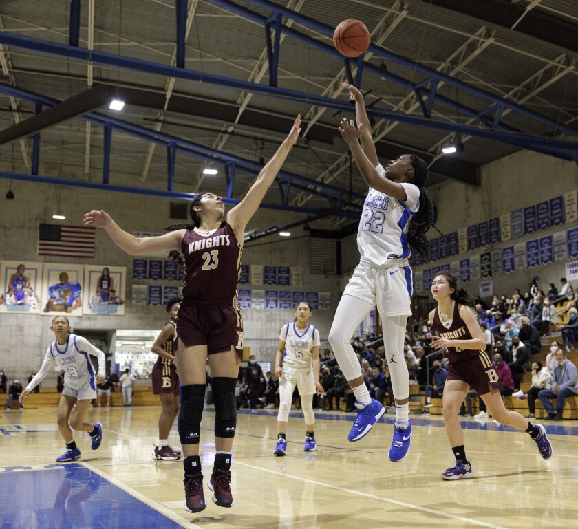 La Jolla Country Day's Taj Avant-Roberts shoots over Natalia Sierra of Bishop's during Country Day's 71-52 victory Feb. 4.