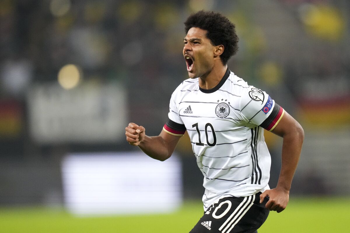 Germany's Serge Gnabry celebrates after scoring his team's first goal during the World Cup 2022 group J qualifying soccer match between Germany and Romania in Hamburg, Germany, Friday, Oct. 8, 2021. (AP Photo/Michael Sohn)