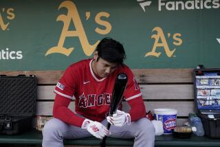 Los Angeles Angels' Shohei Ohtani sits in the dugout before the team's baseball game.