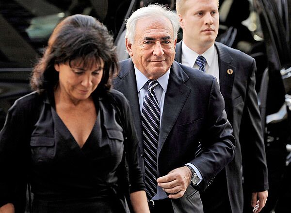Dominique Strauss-Kahn, the former director of the International Monetary Fund, and his wife, Anne Sinclair, left, arrive to state Supreme Court in New York. Prosecutors in the case have filed a recommendation to dismiss the charges against Strauss-Kahn that he sexual assaulted a hotel maid on May 14, 2011.