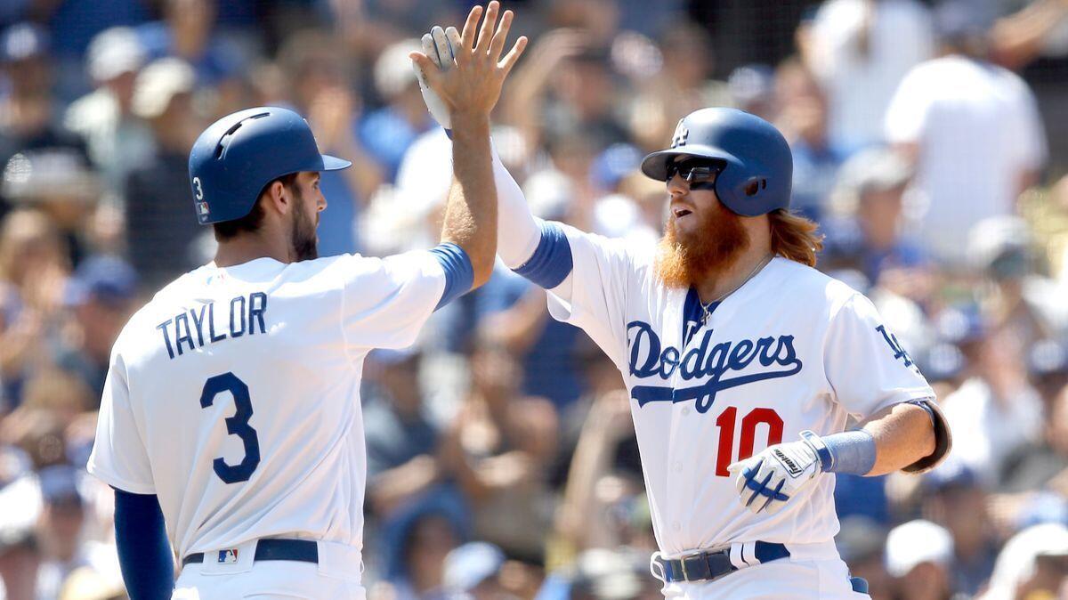 The Dodgers' Justin Turner celebrates his three-run home run with Chris Taylor during the fourth inning against the San Diego Padres on Sunday.