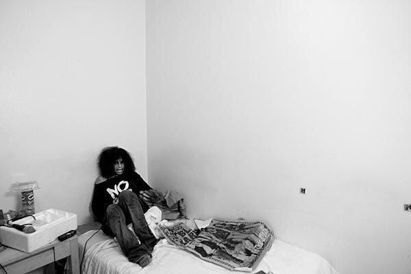 Wanda Hammond sits on her bed in the Senator Hotel. She was No. 5 on the Project 50 list and been found half-clothed on the street in a drug stupor.