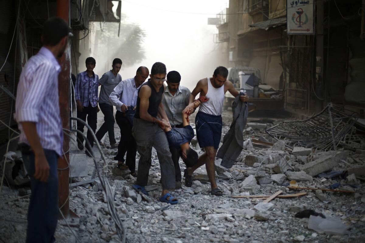 Syrians carry a wounded man after airstrikes hit the rebel-held town of Duma in 2015.