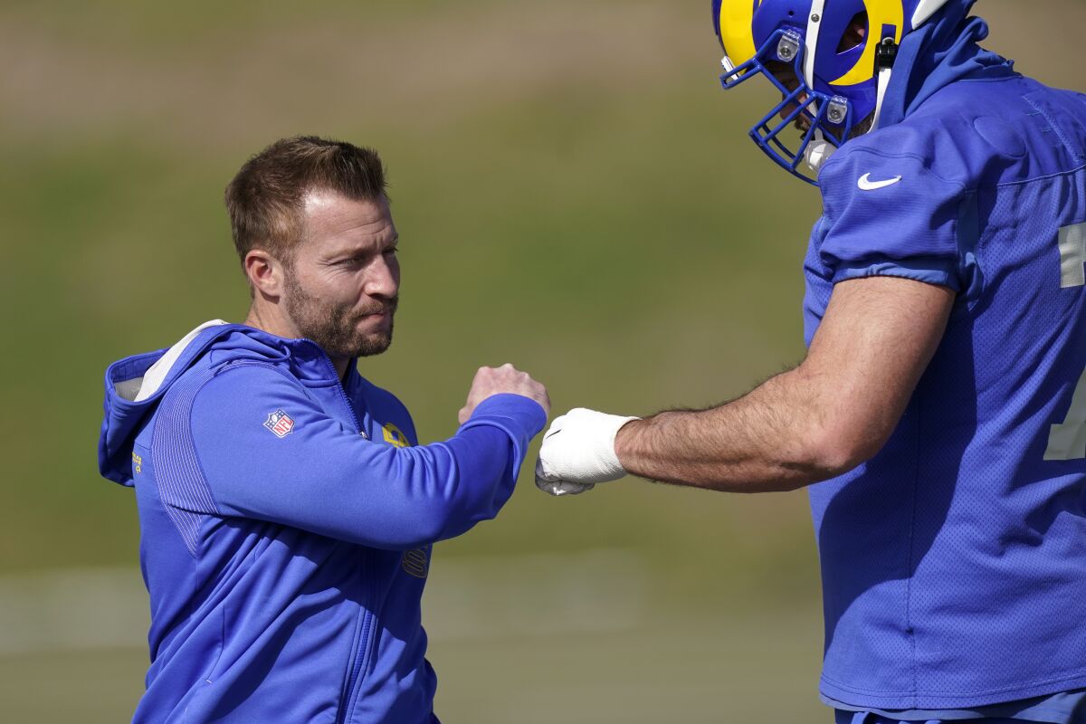Los Angeles Rams head coach Sean McVay, left, greets offensive tackle Andrew Whitworth during an NFL football practice Friday, Jan. 28, 2022, in Thousand Oaks, Calif., ahead of their NFC championship game against the San Francisco 49ers on Sunday. (AP Photo/Mark J. Terrill)