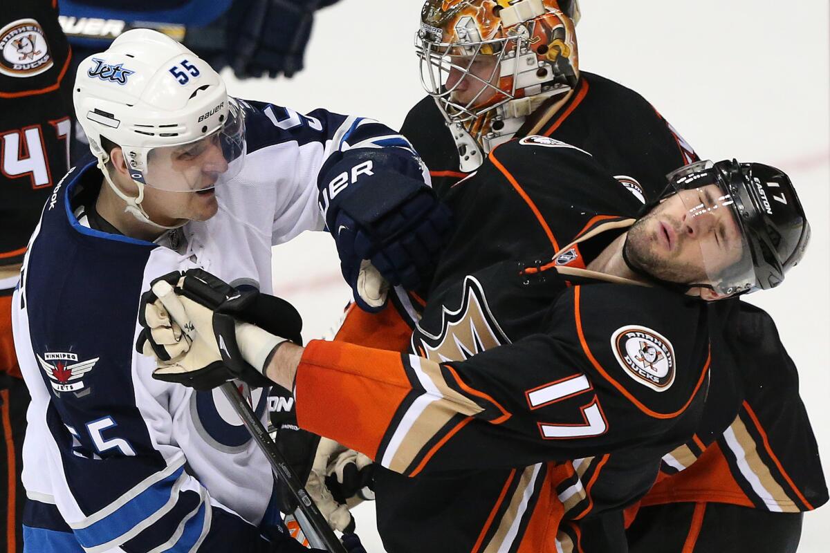 Ducks center Ryan Kesler (17) is shoved in the face by Jets center Mark Scheifele, who was penalized for roughing, in the second period of Game 1.