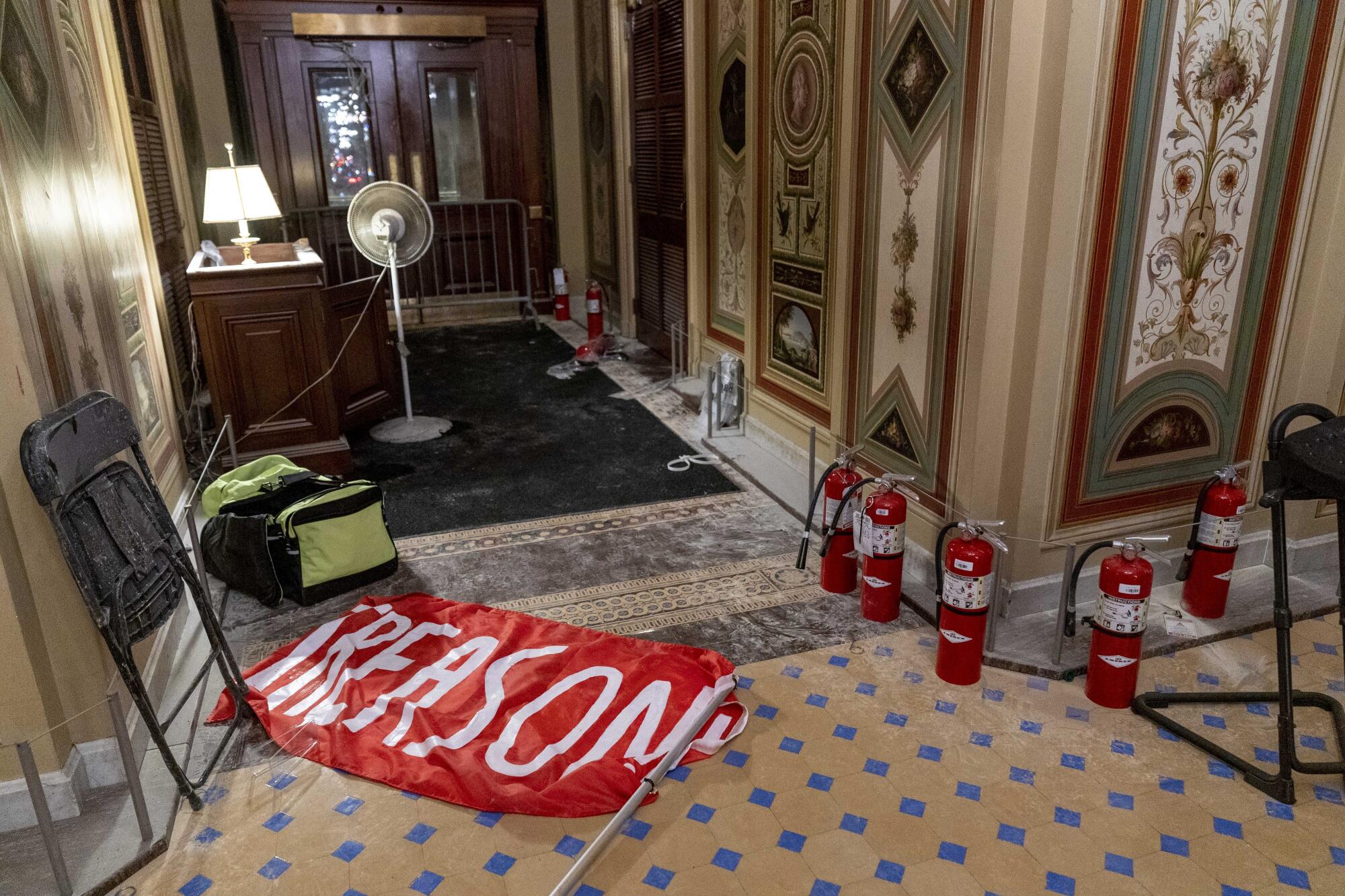 A flag that reads "Treason" lies on the floor in the early morning hours after protesters stormed the Capitol.