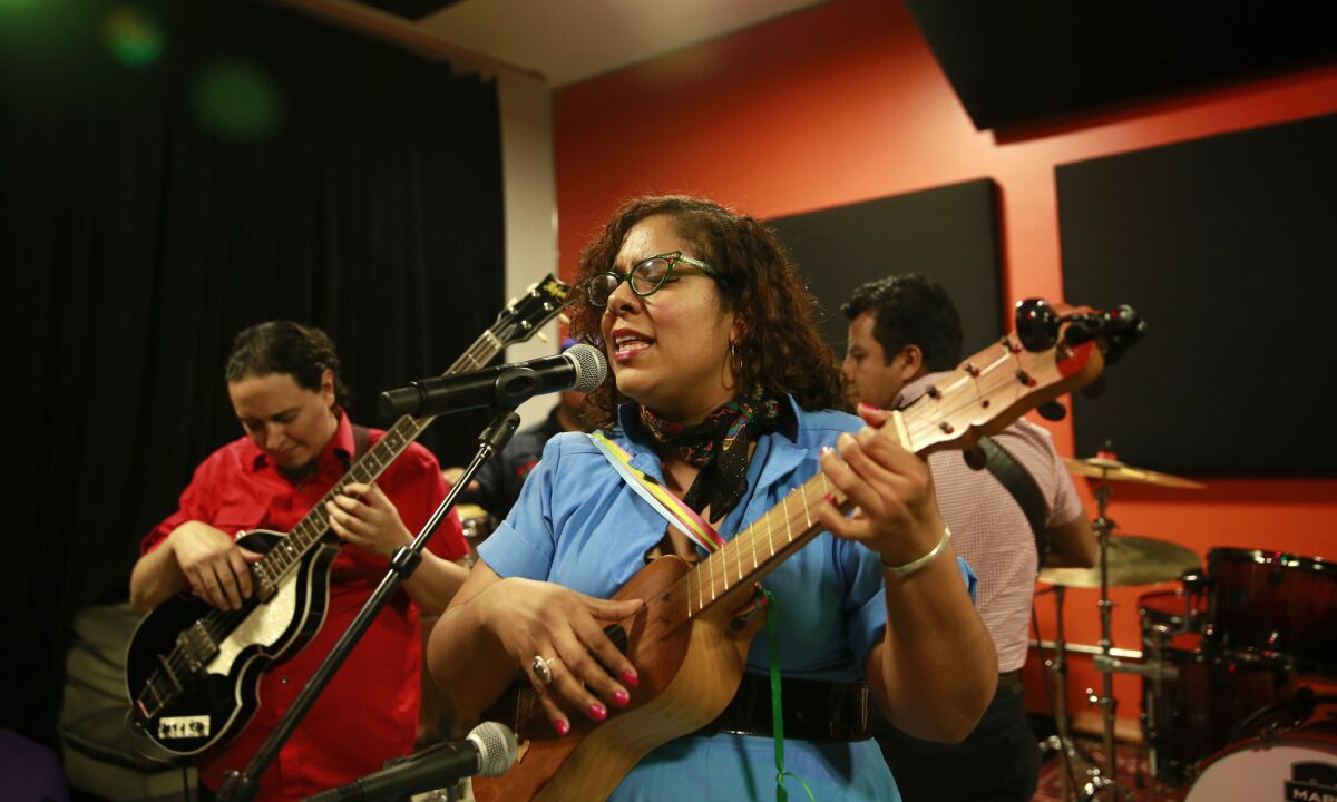 Members of La Santa Cecilia rehearsing for their show at Disney Hall.