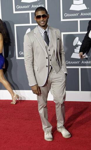 Usher gives his three-piece beige Emporio Armani suit a playful vibe with an oversized check shirt and polka dot tie.