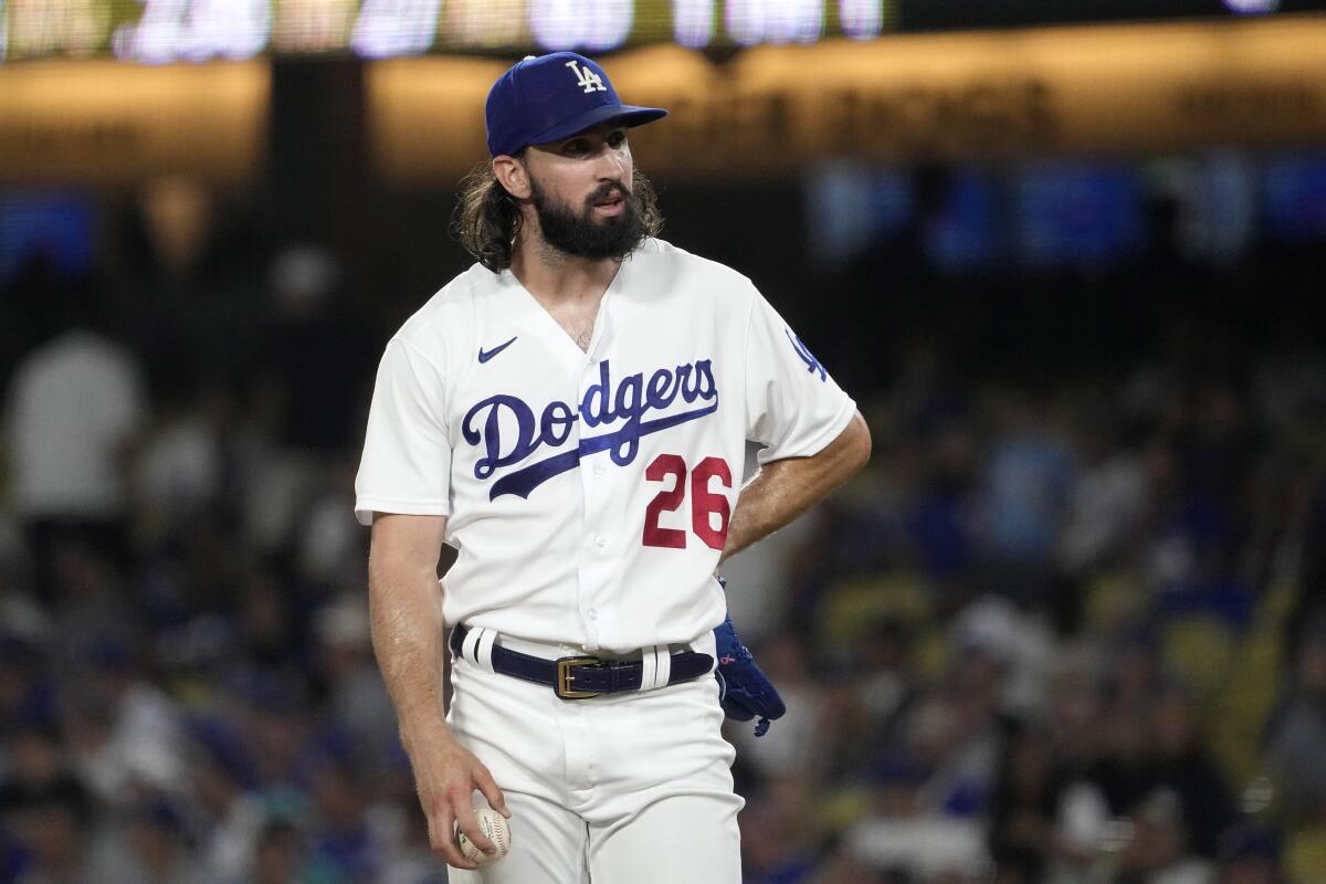 Dodgers pitcher Tony Gonsolin leans to his side and stares from the mound during  a loss