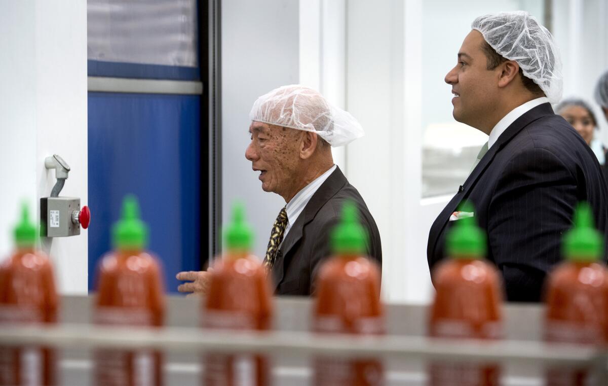 Texas state Rep. Jason Villalba, right, tours the Huy Fong Foods plant, maker of Sriracha hot sauce, with founder and Chief Executive David Tran in Irwindale.