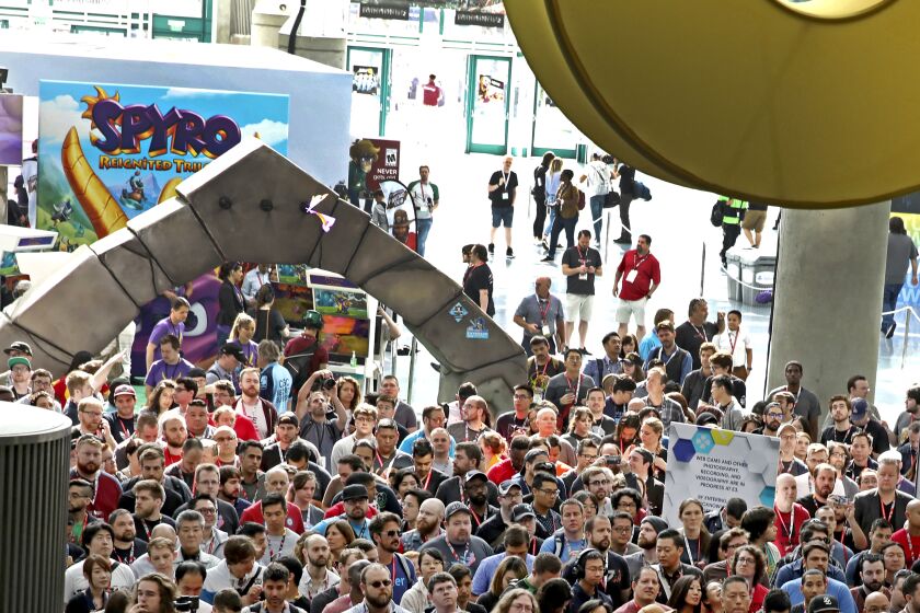 E3 fans line up near the "Spyro Reignited Trilogy" booth, ready to get their game on at the Los Angeles Convention Center on Wednesday, June 13, 2018 in Los Angeles. (Photo by Colin Young-Wolff/Invision for Activision/AP Images)