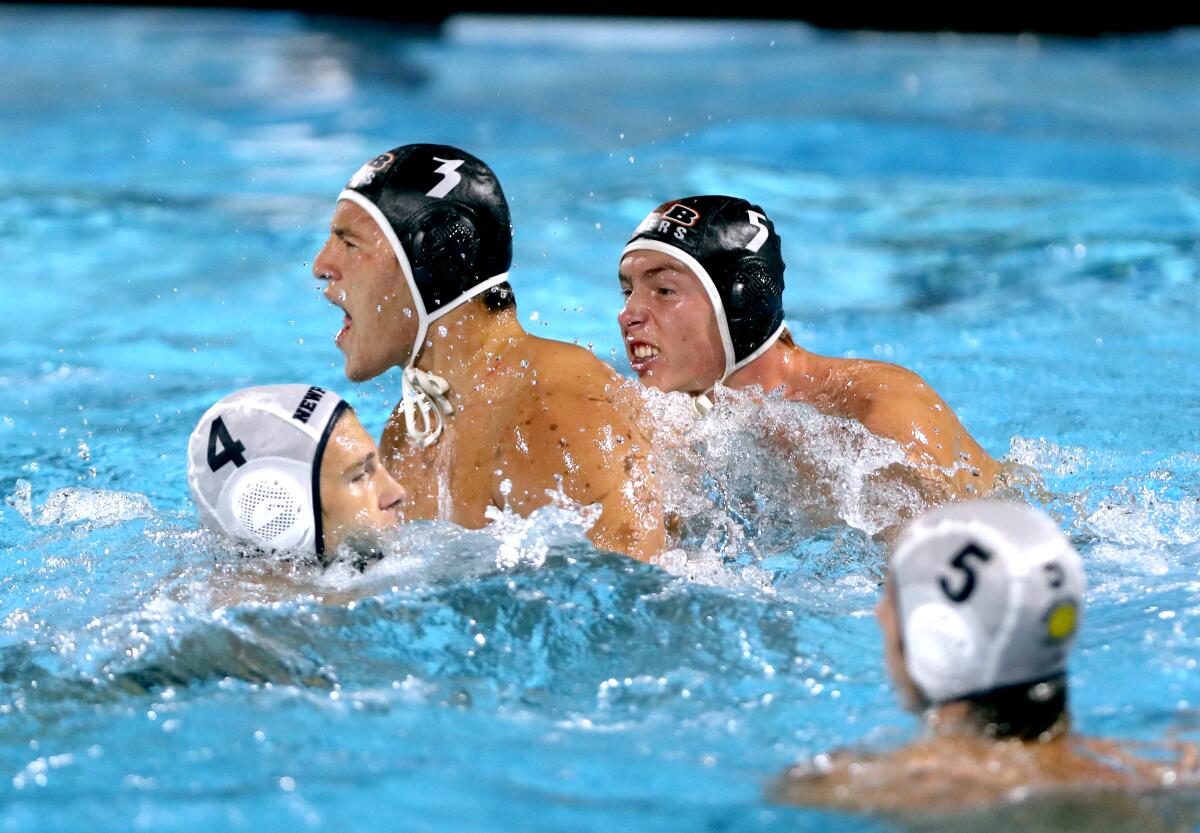Huntington Beach High boys' water polo players Nikola Mirkovic (3) and Tas Palcza (5) celebrate Mirkovic's go-ahead goal.
