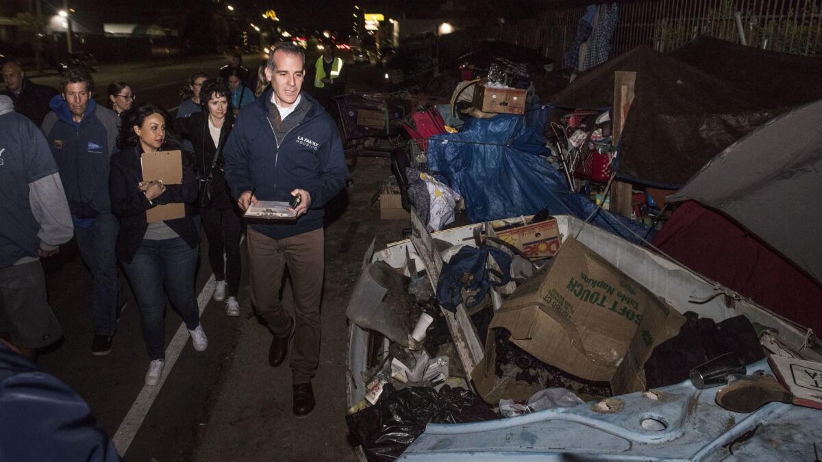 Los Angeles Mayor Eric Garcetti walks along Webb Avenue to help tally the city's homeless population during the first day of the Greater Los Angeles Homeless Count in North Hollywood this month.